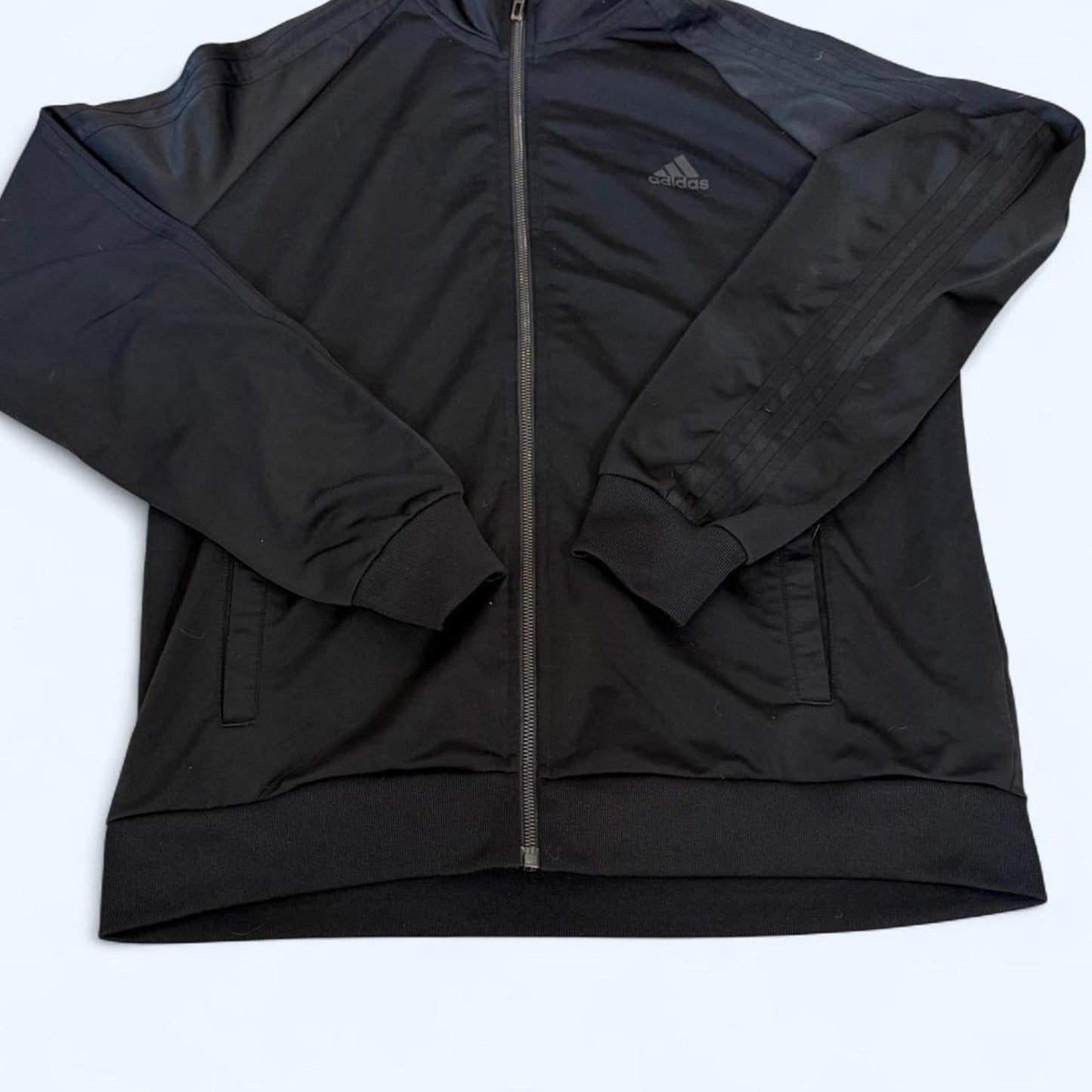 Clean black Adidas track jacket with subtle logo