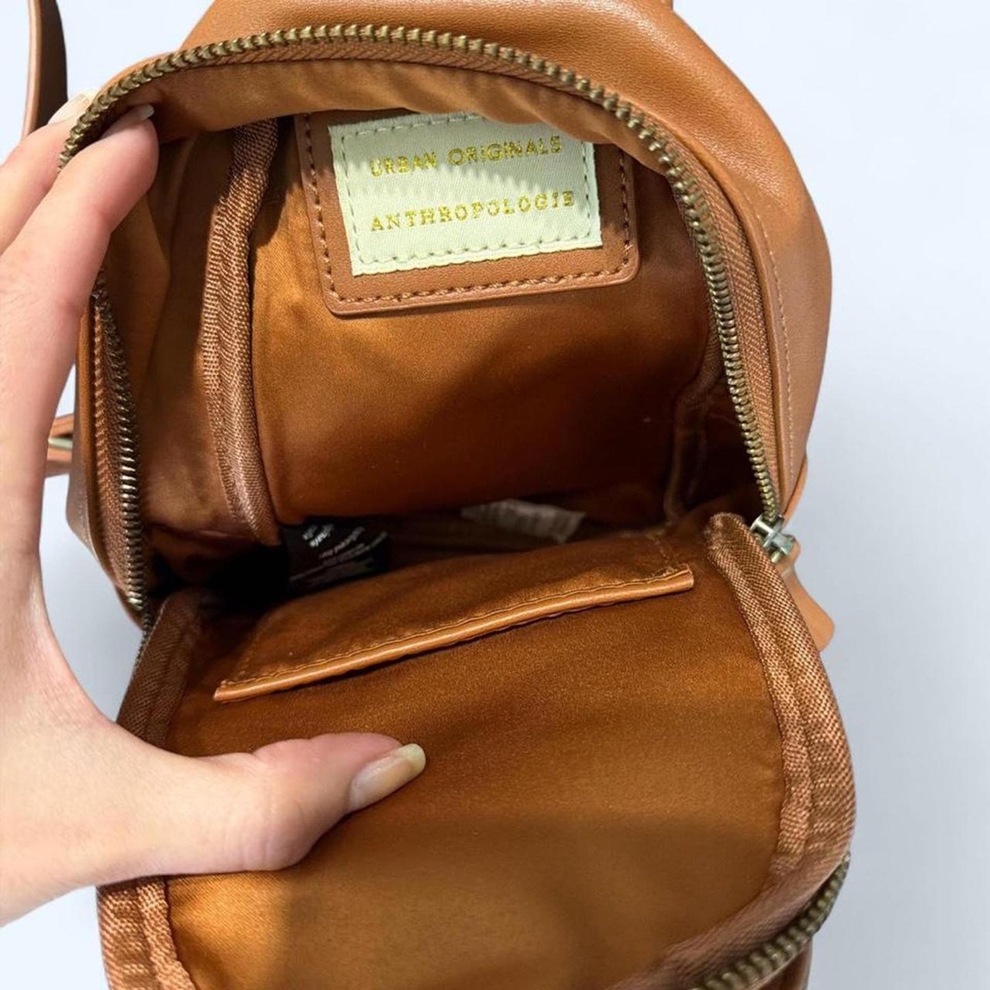 Tan leather crossbody bag with woven design from Anthropology