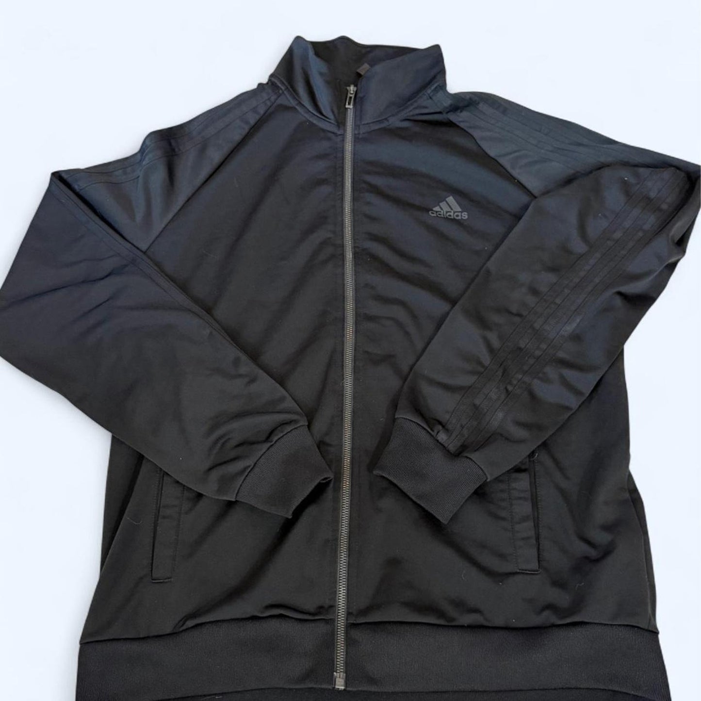 Clean black Adidas track jacket with subtle logo
