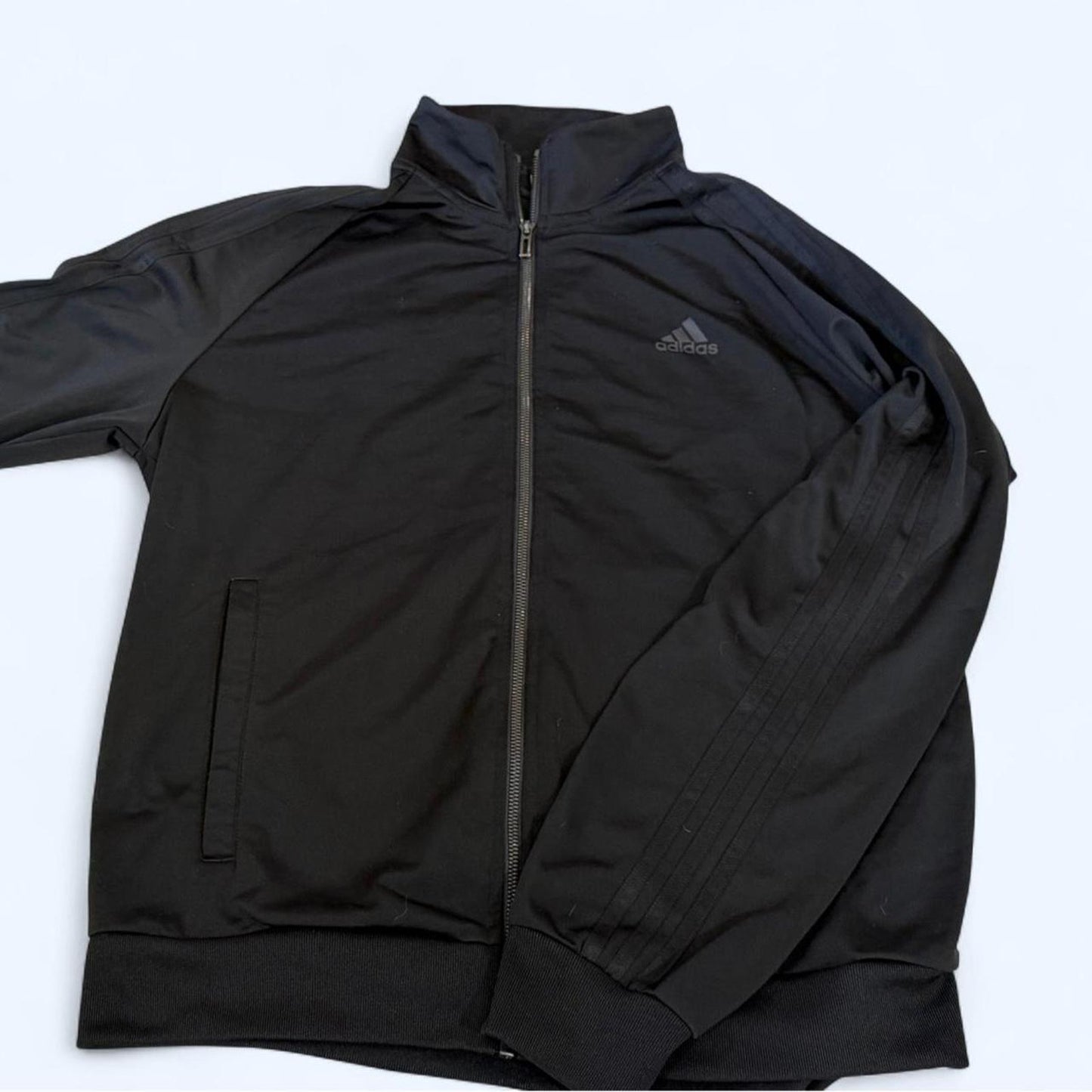 Clean black Adidas track jacket with subtle logo