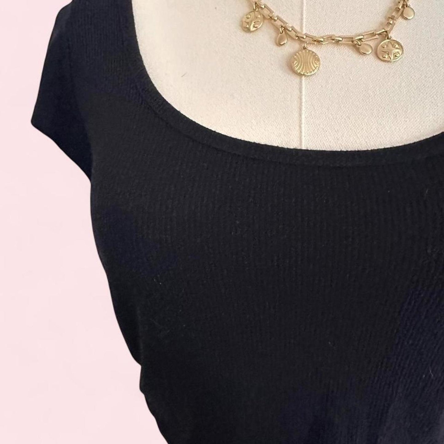 black crop top with scoop neck and short sleeves