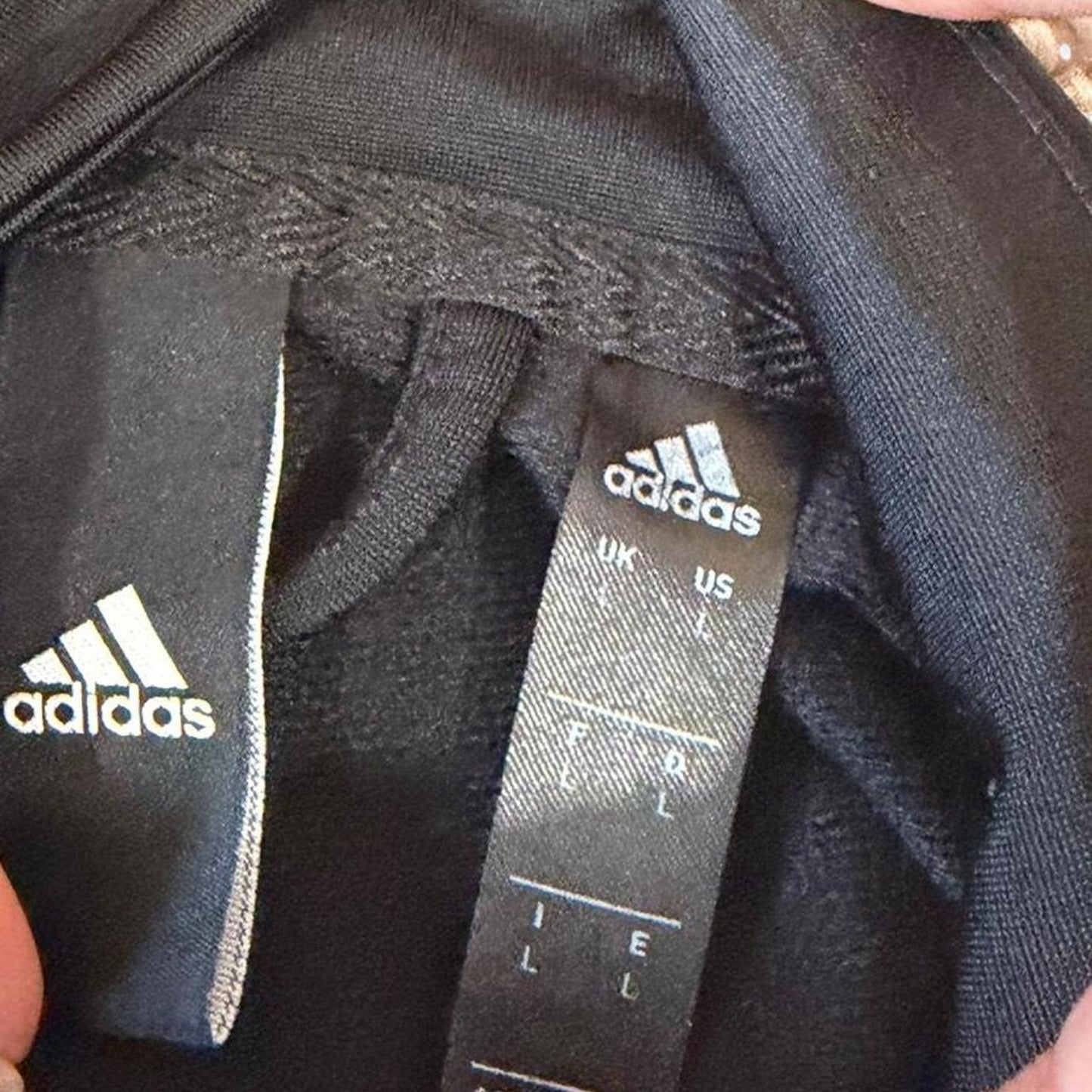 Clean black Adidas track jacket with subtle logo